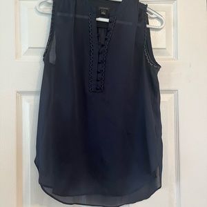 Pretty navy sleeveless blouse. Sheer. Button placket.